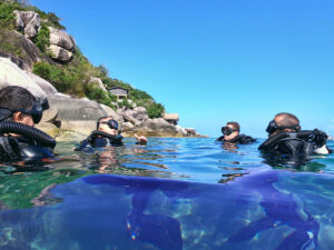 Four technical divers exhibit the Big Blue Tech philosophy by doing final surface checks before a long dive.